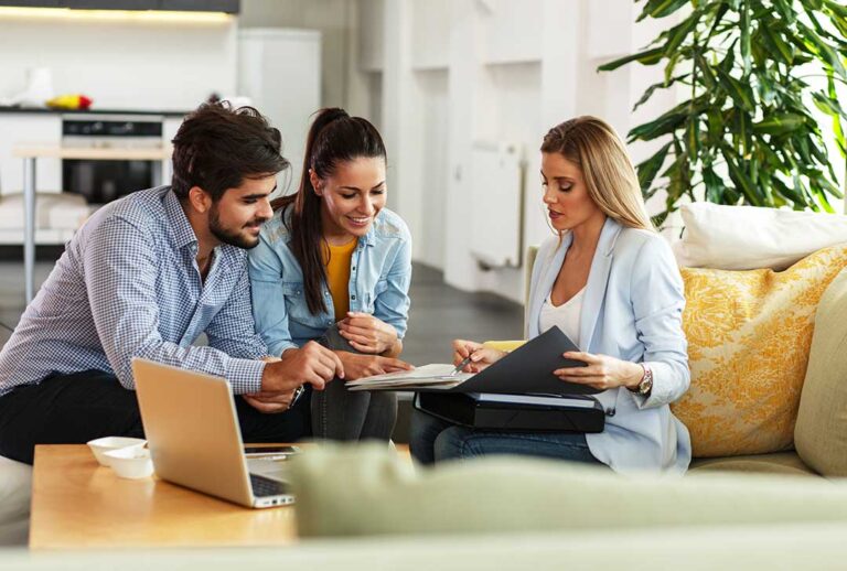 Person reviewing an insurance bill and cancellation notice beside a phone and payment confirmation.